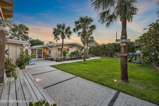 view of yard featuring a patio area and a playground