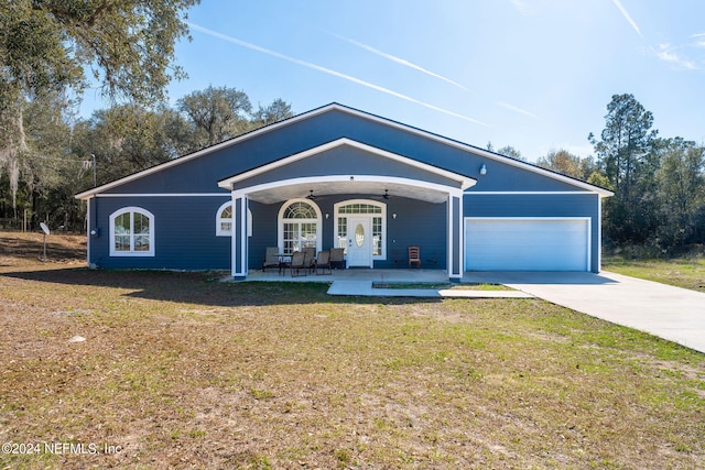 single story home with a garage, a front lawn, and ceiling fan