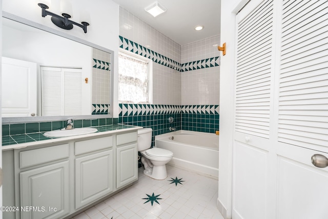 bathroom with tile walls, tile patterned floors, vanity, and toilet