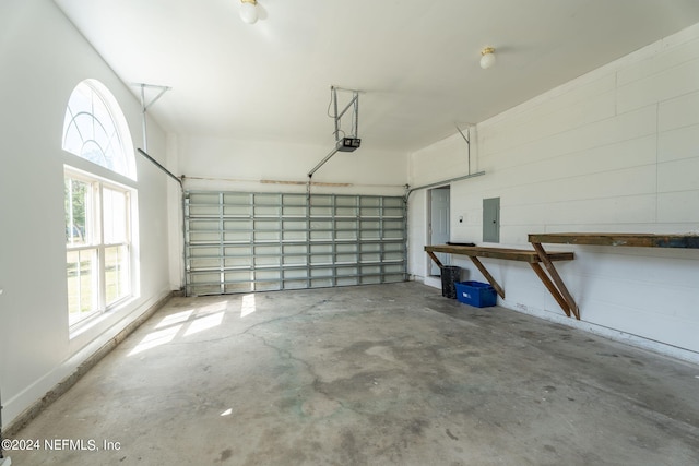 garage featuring electric panel and a garage door opener