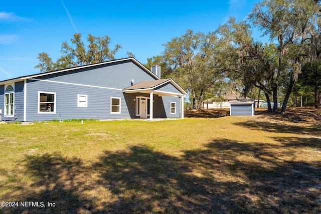 rear view of property with a yard