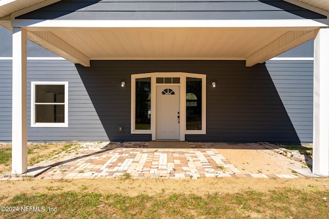 property entrance featuring a patio