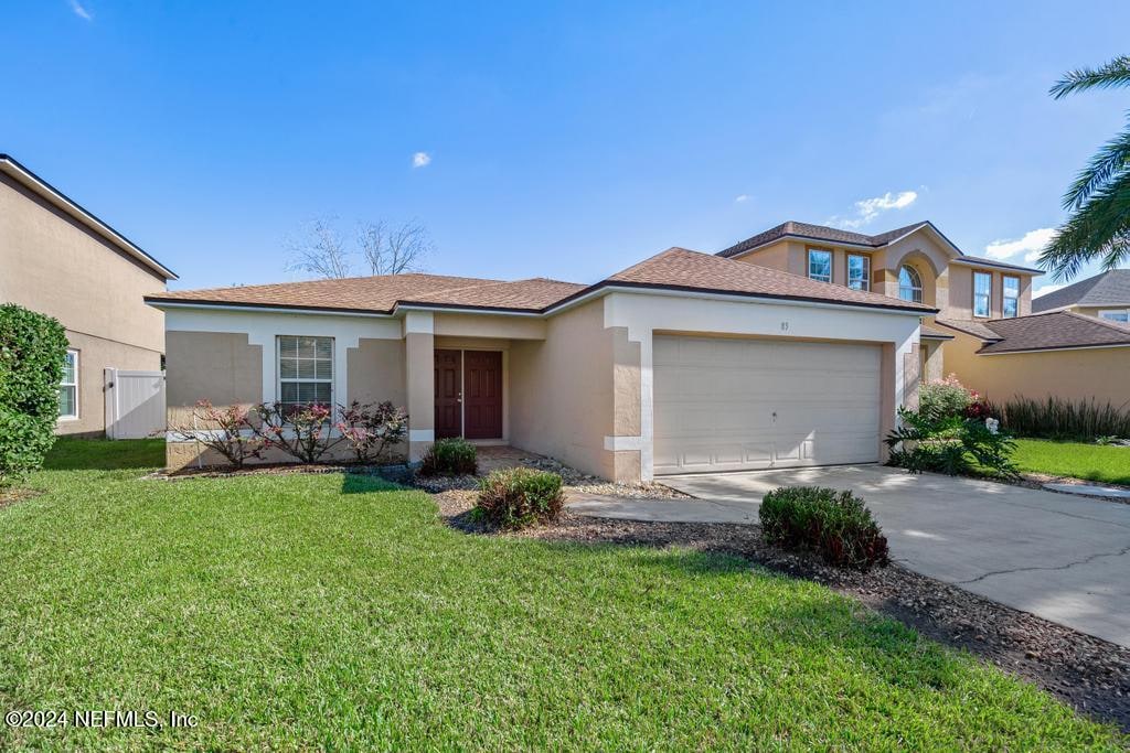 view of front of house with a front lawn and a garage