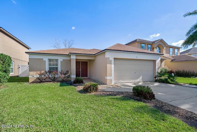 view of front of house with a front lawn and a garage