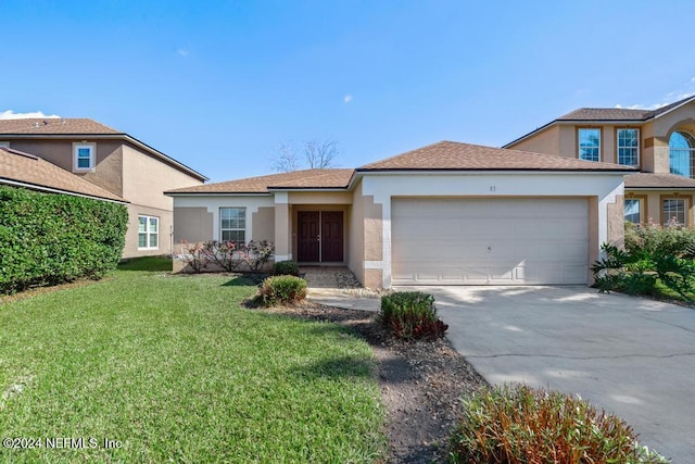 view of front of house featuring a front lawn and a garage