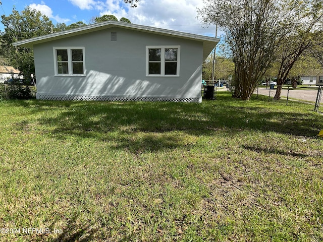 view of property exterior with a yard