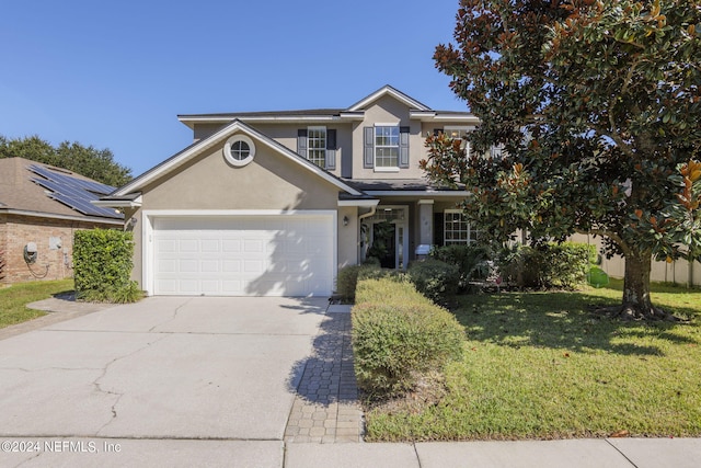 view of front facade featuring a front lawn and a garage