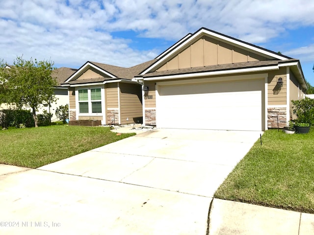 craftsman-style home featuring a garage and a front lawn