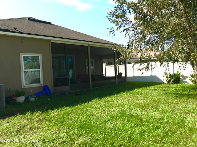 view of yard featuring a sunroom