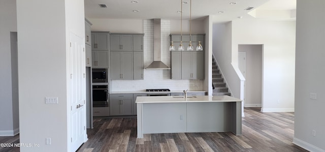 kitchen with sink, wall chimney exhaust hood, dark hardwood / wood-style floors, and oven