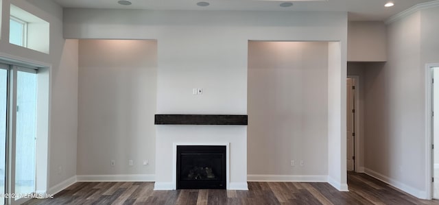 unfurnished living room featuring a towering ceiling and dark hardwood / wood-style floors