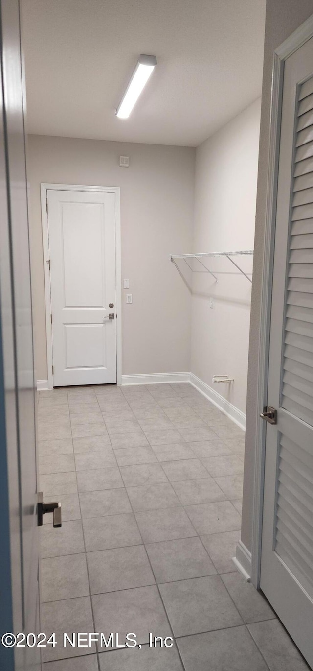 laundry room with light tile patterned flooring