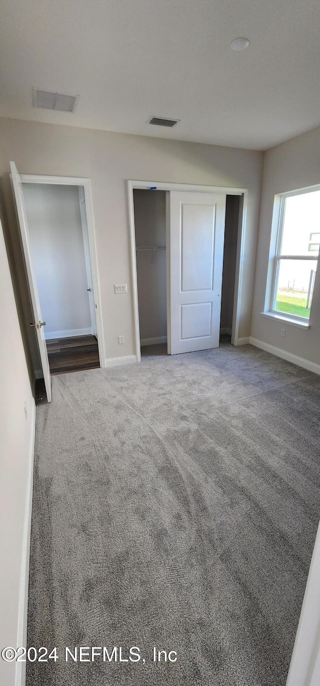 unfurnished bedroom with a closet and carpet