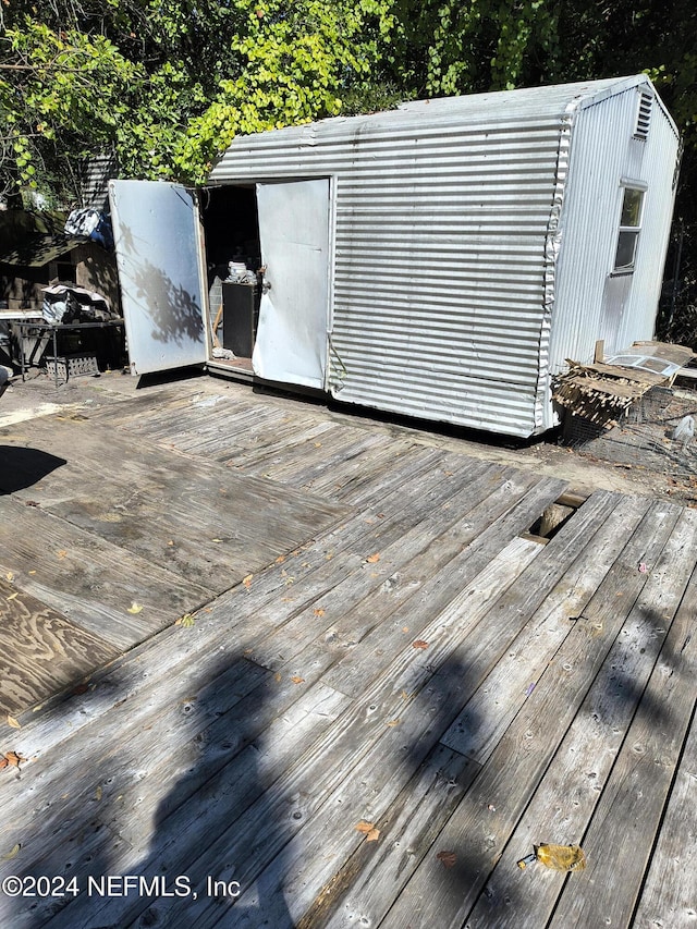 wooden terrace with a shed