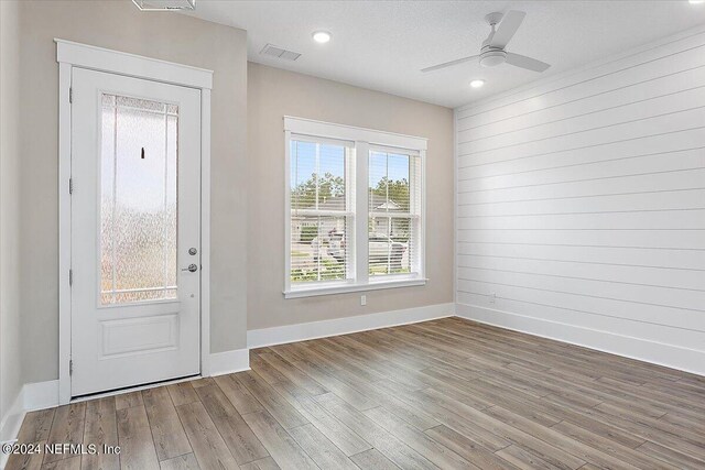 entryway with ceiling fan and wood-type flooring