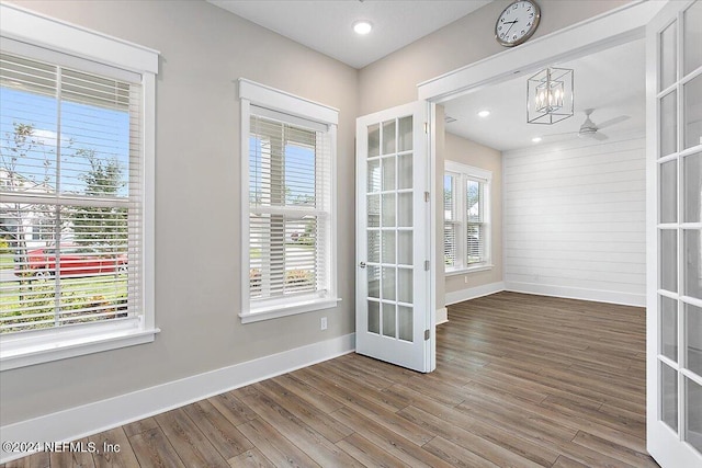 spare room with hardwood / wood-style flooring, ceiling fan, and french doors