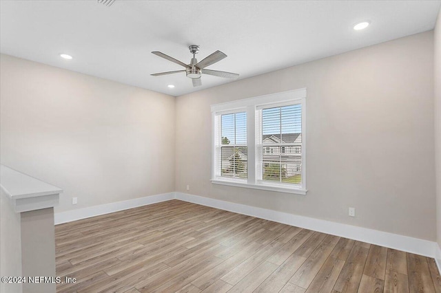 unfurnished room featuring ceiling fan and light hardwood / wood-style flooring