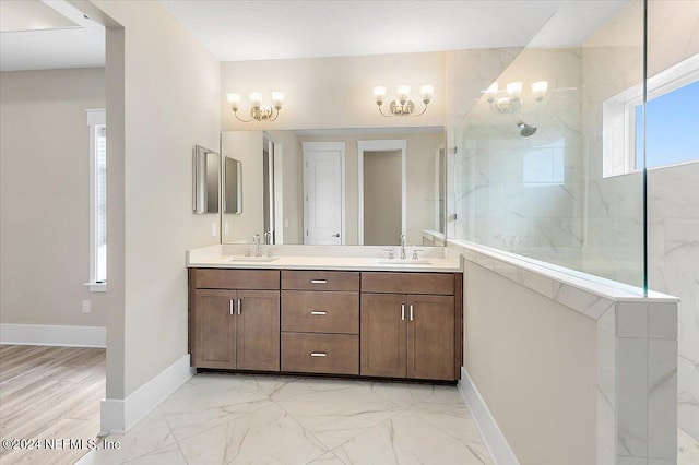 bathroom featuring a tile shower and vanity