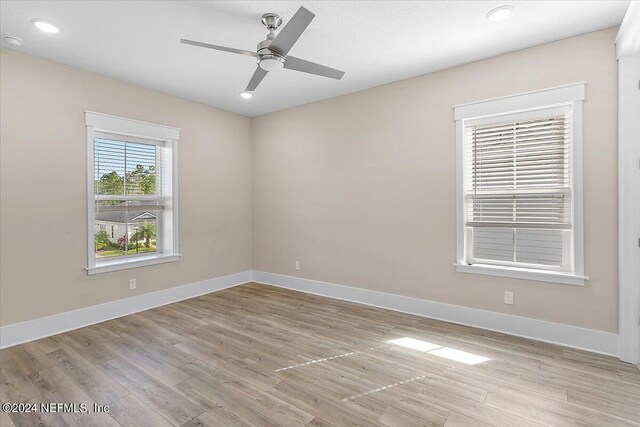 spare room featuring ceiling fan and light wood-type flooring