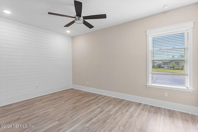 spare room with ceiling fan and light wood-type flooring