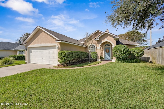 view of front of home with a front lawn and a garage