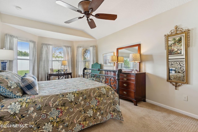 bedroom with ceiling fan, lofted ceiling, and light colored carpet