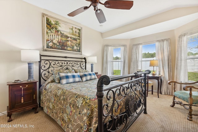 bedroom featuring vaulted ceiling, light carpet, and ceiling fan