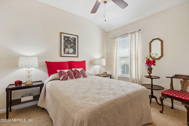 bedroom featuring vaulted ceiling, light colored carpet, and ceiling fan