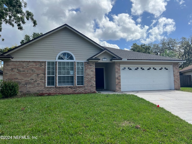 ranch-style home with a front yard and a garage