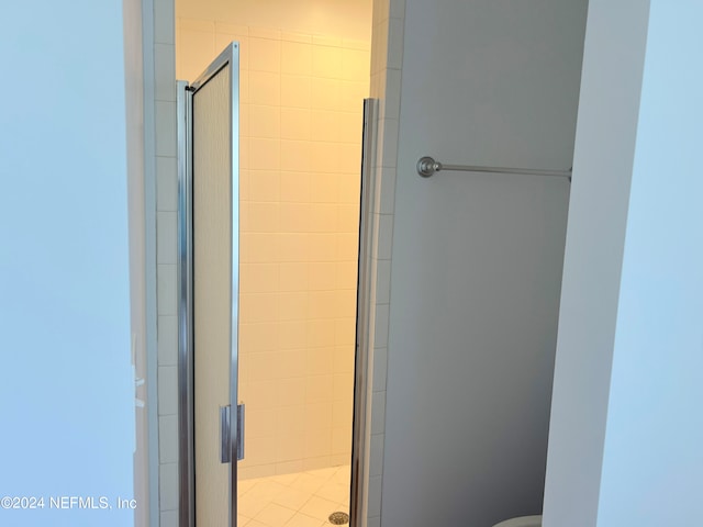 bathroom featuring a shower with shower door