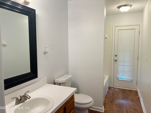 bathroom featuring vanity, a textured ceiling, toilet, and hardwood / wood-style flooring