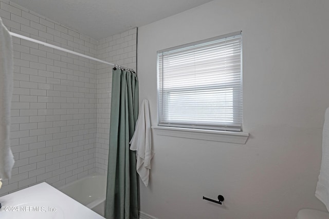 bathroom with toilet and shower / bathtub combination with curtain