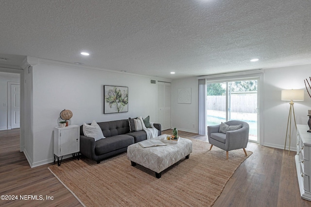 living room with a textured ceiling and hardwood / wood-style flooring