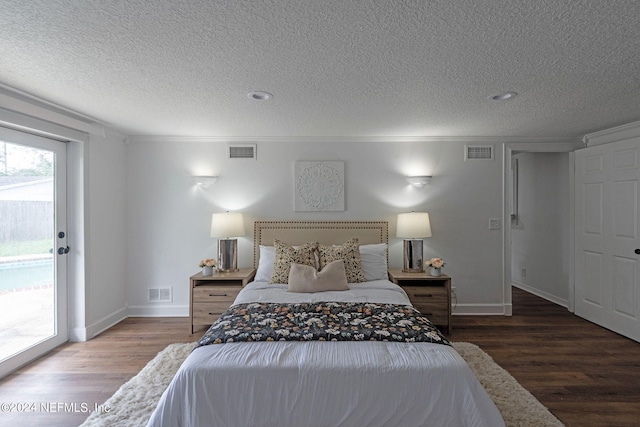 bedroom with access to outside, a textured ceiling, dark wood-type flooring, and crown molding