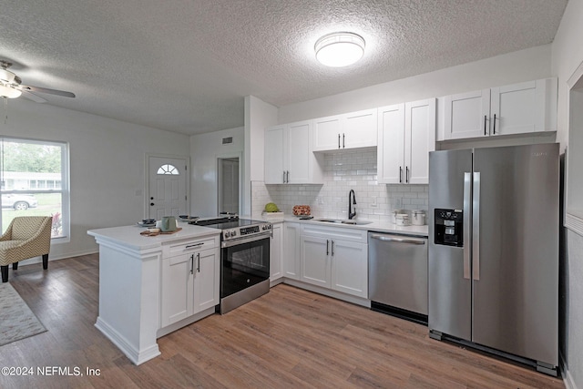 kitchen featuring light hardwood / wood-style floors, stainless steel appliances, sink, and white cabinets