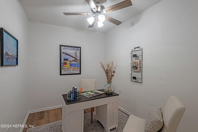 home office featuring a textured ceiling, hardwood / wood-style flooring, and ceiling fan