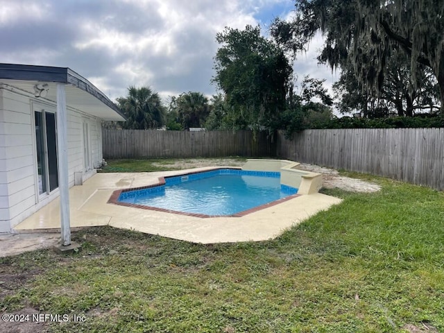 view of pool featuring a patio area and a lawn