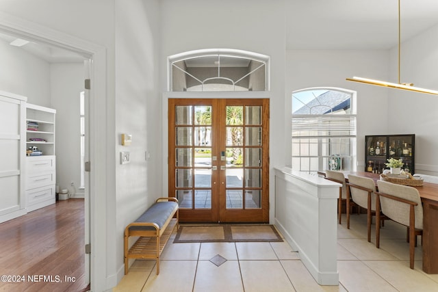 entryway featuring french doors and light tile patterned flooring