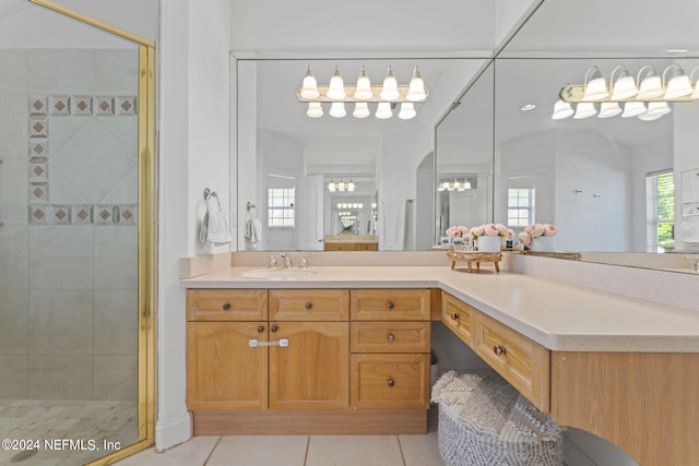 full bath featuring tile patterned flooring, vanity, and a shower stall