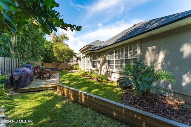 view of yard with a fenced backyard and a deck