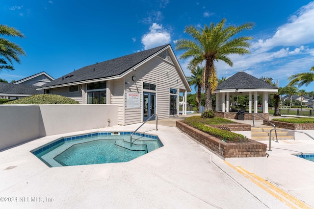 view of pool with a gazebo, french doors, a patio, and fence