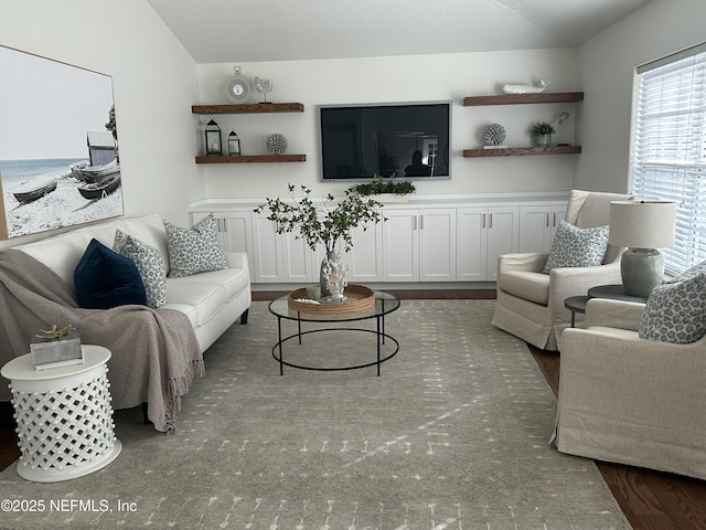 living room featuring vaulted ceiling and wood finished floors