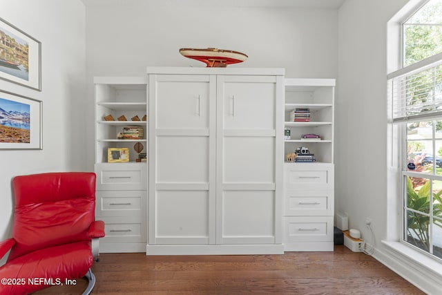 sitting room with baseboards and dark wood-style flooring