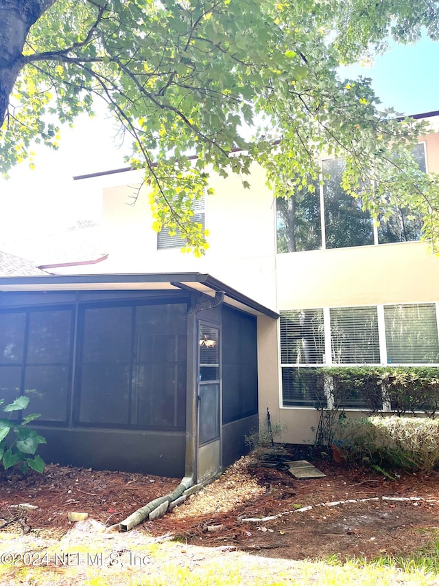 view of side of property with a sunroom