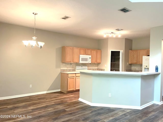 kitchen featuring dark hardwood / wood-style flooring, kitchen peninsula, hanging light fixtures, tasteful backsplash, and white appliances