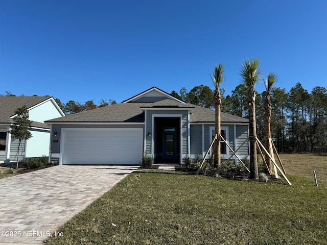 view of front of house with a front lawn and a garage