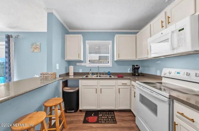 kitchen with white cabinets, sink, and white appliances