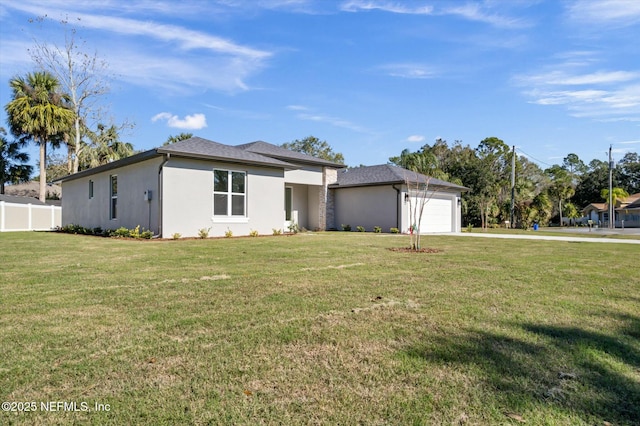 view of front of property featuring a front yard and a garage