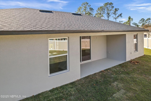 rear view of property with a lawn and a patio area