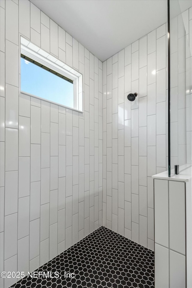 bathroom with a tile shower